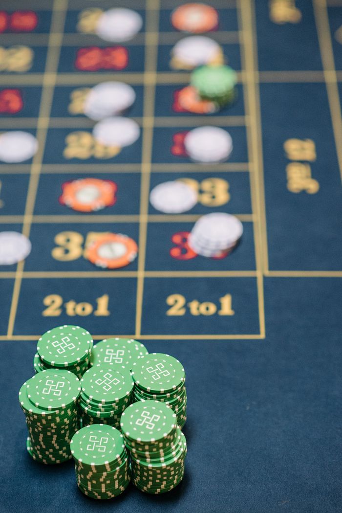 Mastering the First Impression: Your intriguing post title goes here Green casino chips stacked on a roulette table with number layout and betting areas visible.