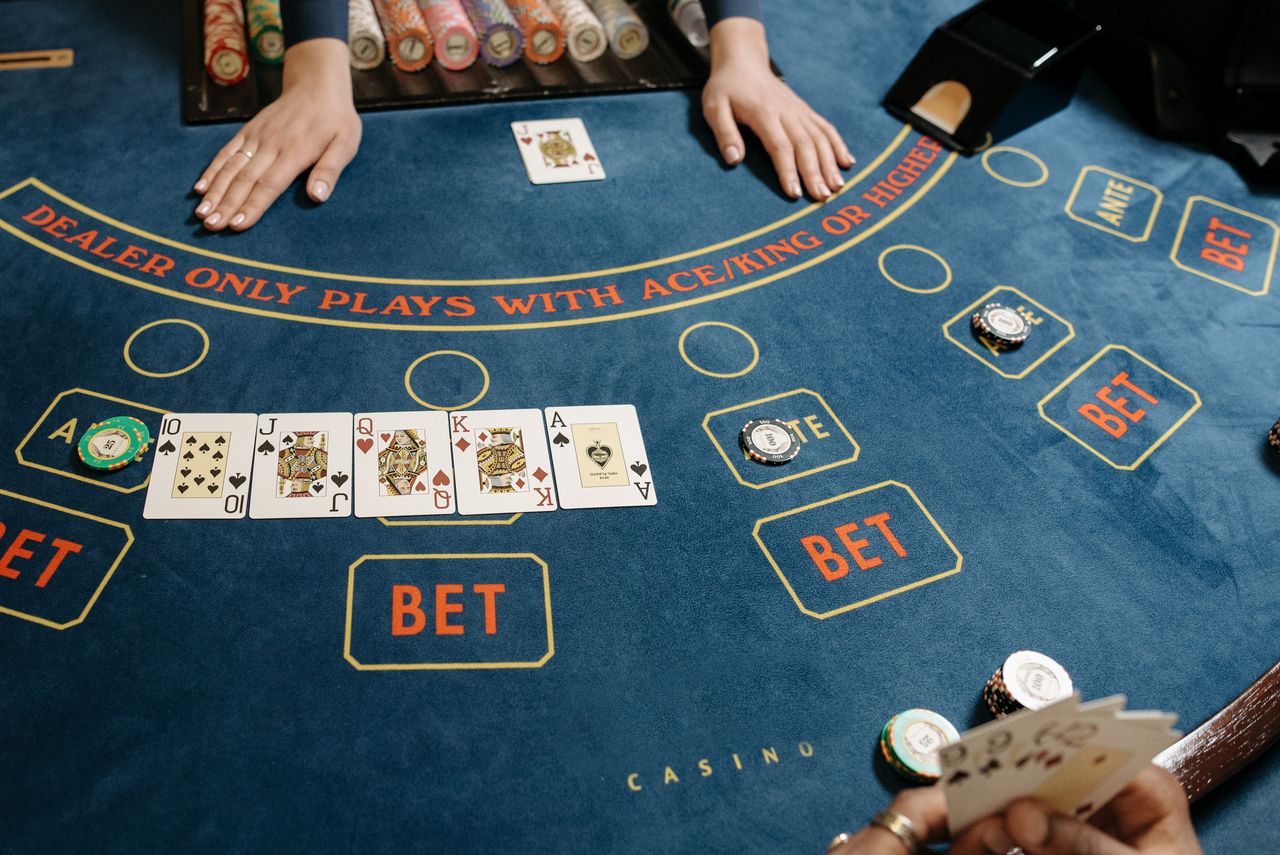 Services A casino gaming table featuring poker cards and chips, showcasing a vibrant gambling scene.