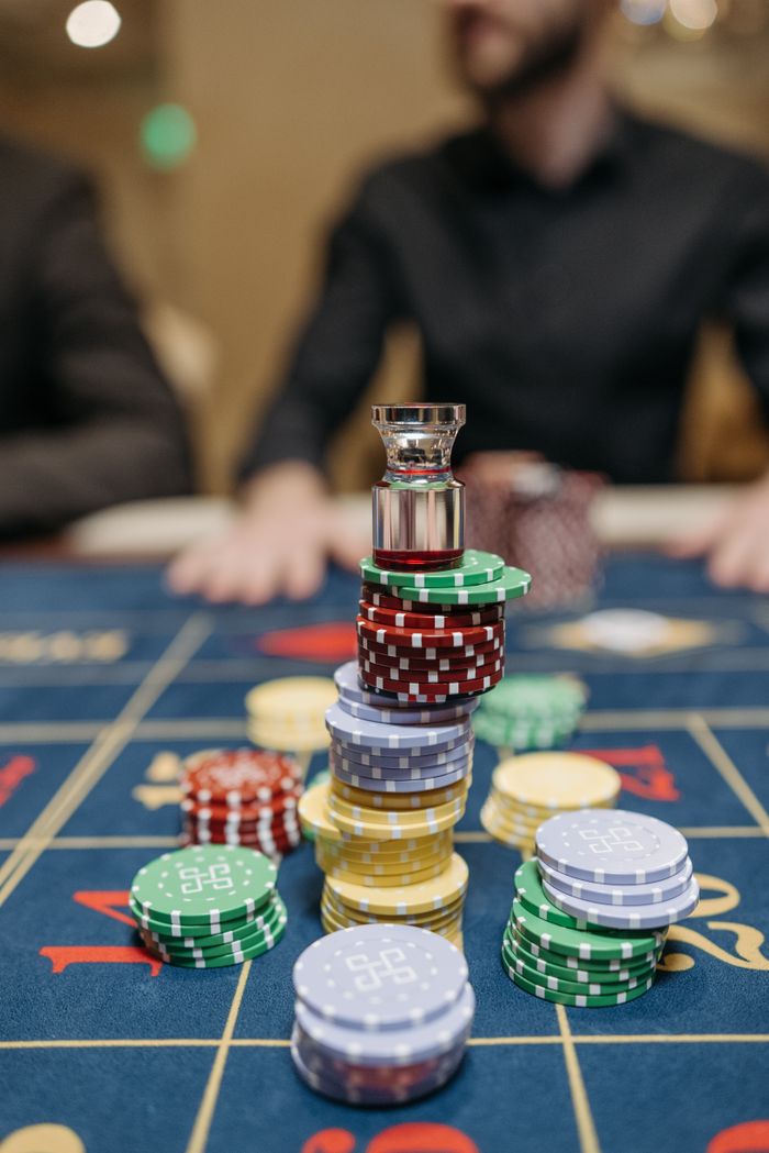 Crafting Captivating Headlines: Your awesome post title goes here Close-up of colorful casino chips stacked on a roulette table in a casino setting.